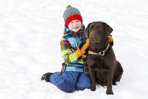 Kid of school age with dog in winter park