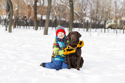 Kid of school age with dog in winter park