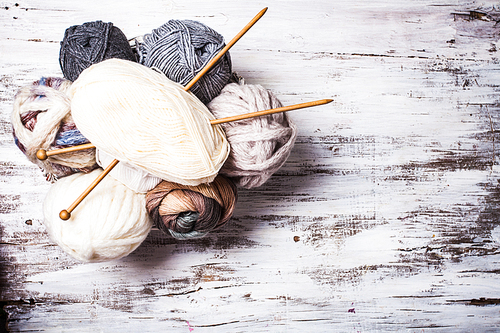Beige and gray color threads and wooden knitting needles with copy space