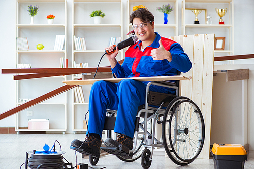 Disabled carpenter working with tools in workshop