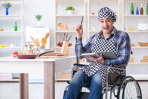 Young man cook with book of food recipes