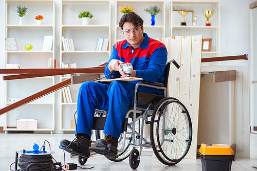 Disabled carpenter working with tools in workshop