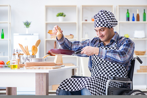 Disabled young husband frying at kitchen