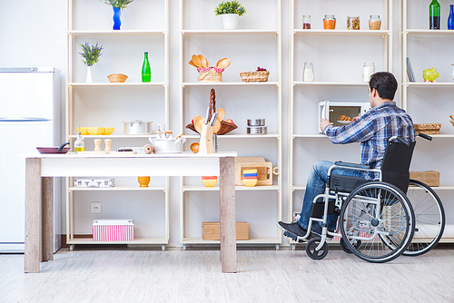 Disabled young man husband working in kitchen