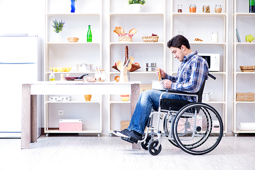 Disabled man preparing soup at kitchen