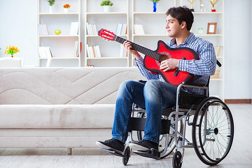 Disabled man playing guitar at home