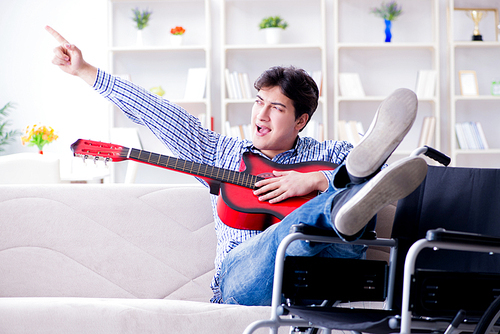 Disabled man playing guitar at home