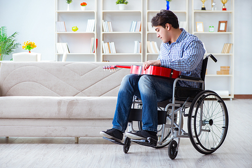 Disabled man playing guitar at home