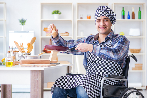 Disabled young husband frying at kitchen