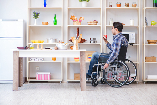 Disabled young man husband working in kitchen