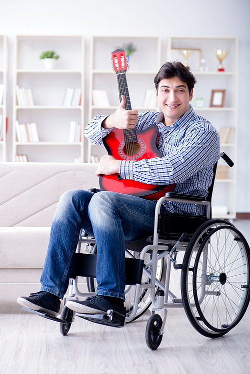 Disabled man playing guitar at home