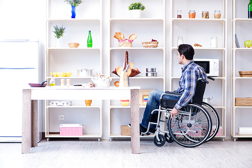 Disabled young man husband working in kitchen