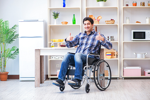 Disabled young man husband working in kitchen