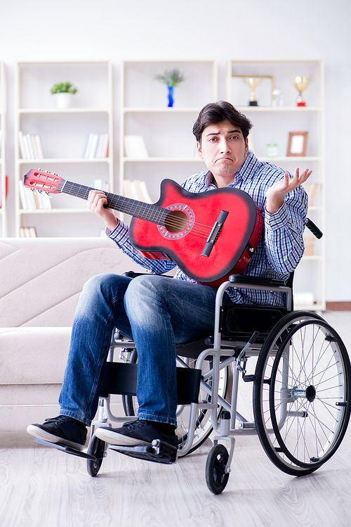 Disabled man playing guitar at home