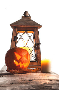 Halloween pumpkin and lantern with candle on white background