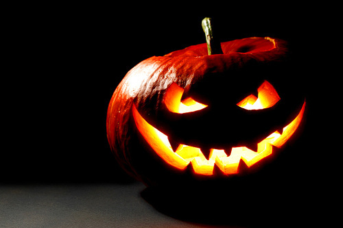 Scary smiling Halloween pumpkin on dark background