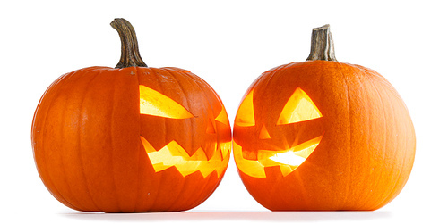 Two Halloween Pumpkins looking to each other isolated on white
