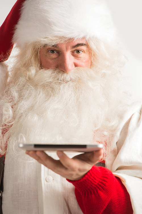 Santa Claus working on tablet computer closeup portrait