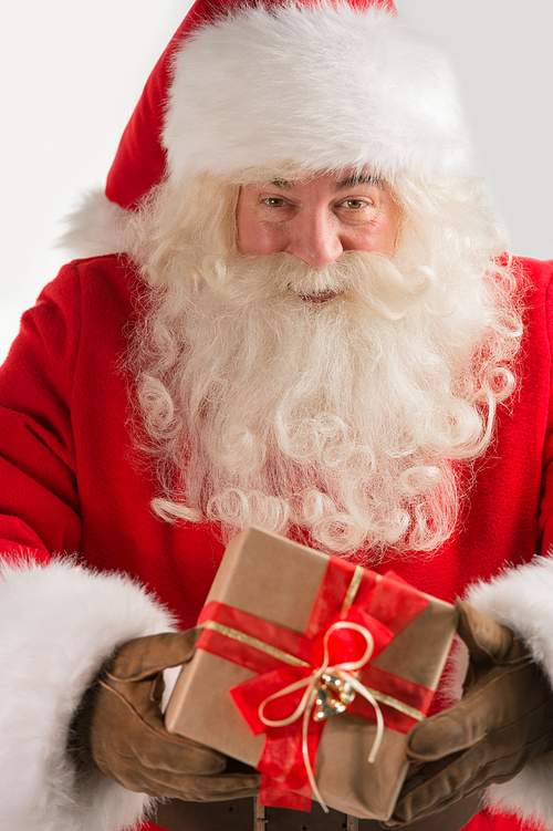 Portrait of kind Santa Claus with christmas present and 