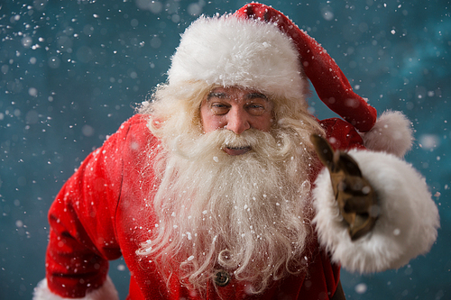 Santa Claus running outdoors at North Pole. Trying to be in time working on delivery gifts to children