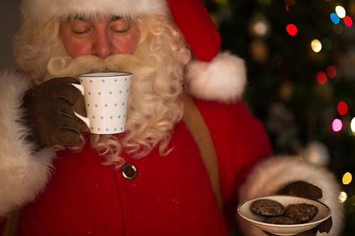 Santa Claus at Home eating cookies and drinking milk