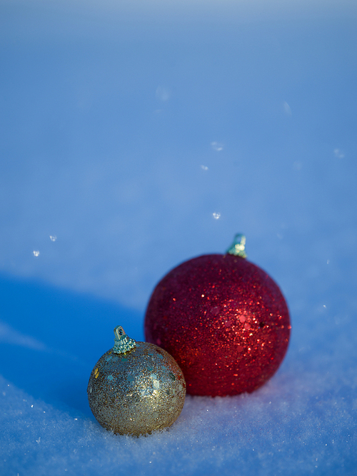 christmas balls tree decoration in fresh snow abstract background