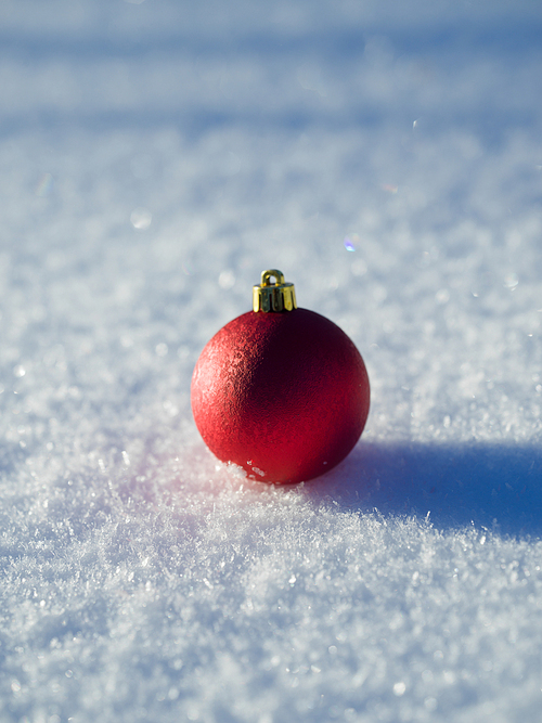 christmas balls tree decoration in fresh snow abstract background