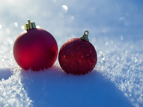 christmas balls tree decoration in fresh snow abstract background