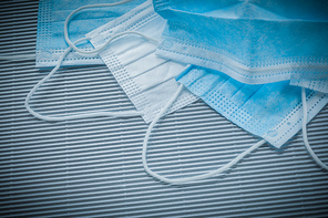 Composition of surgical sterile masks on striped background.