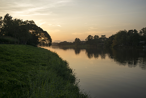 Silhouette of trees at riverside at sunset, Chiang Rai, Thailand