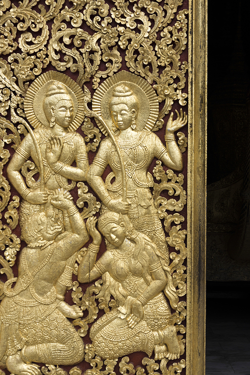 Sculpture carved on door of temple, Wat Xieng Thong temple, Luang Prabang, Laos