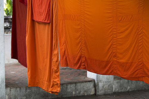 Close-up of orange color robes drying, Luang Prabang, Laos