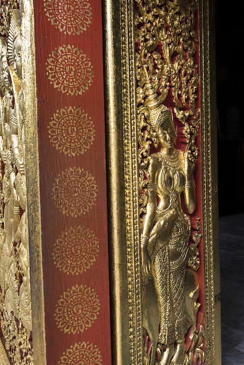 Sculpture carved on door of temple, Wat Xieng Thong temple, Luang Prabang, Laos