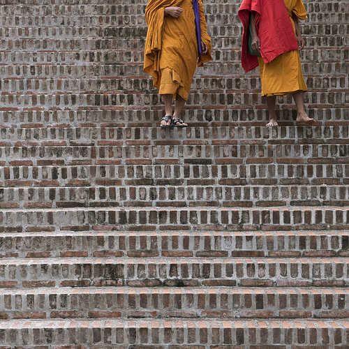 Monks walking down staircase, Luang Prabang, Laos