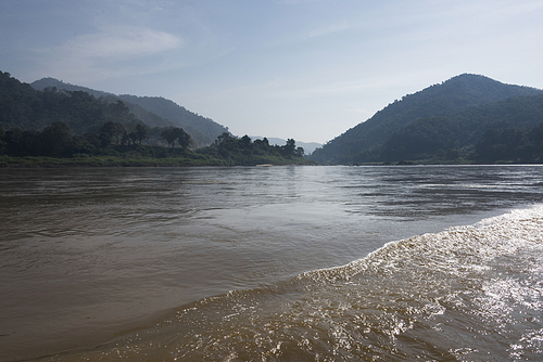 Scenic view of river with mountain range in background, River Mekong, Laos