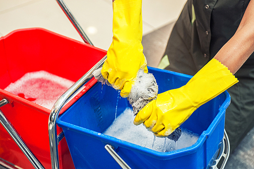 Cleaning concept. Closeup photo of woman cleaning shopping center