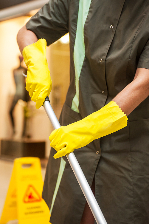 Cleaning concept. Closeup photo of woman cleaning shopping mall