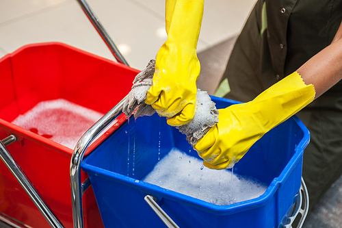 Cleaning concept. Closeup photo of woman cleaning shopping center