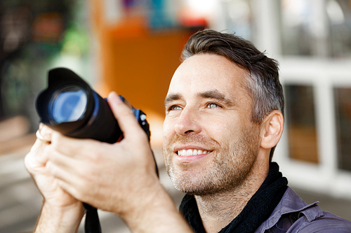 Professional photographer taking picture in city