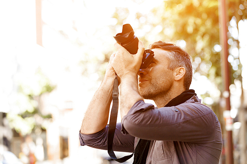 Professional photographer taking picture in city
