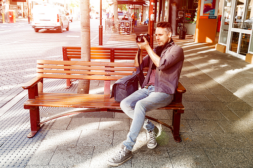 Professional photographer taking picture in city