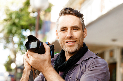 Professional photographer taking picture in city