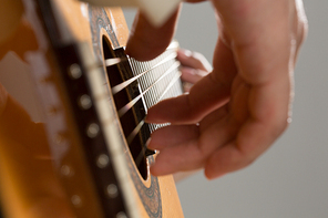 Close up of male hands playing acoustic guitar