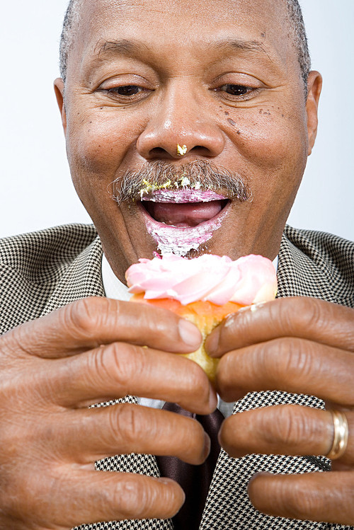Businessman eating a cupcake