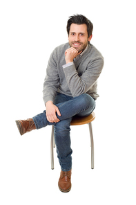 happy casual man on a chair, isolated on white