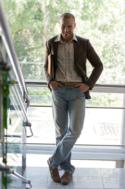 Relaxed businessman standing in office