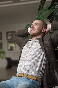 Satisfied businessman relaxing in his office or restaurant