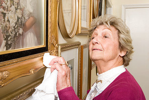 Woman polishing picture frames