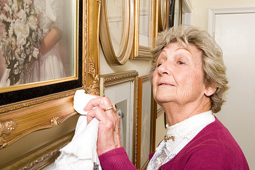 Woman polishing picture frames