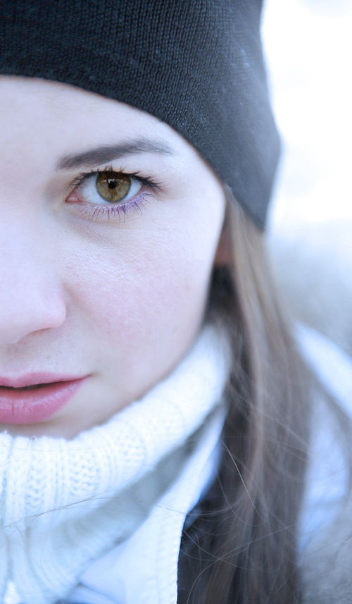 Close up portrait of a young girl with intense eye contact. Winter concept